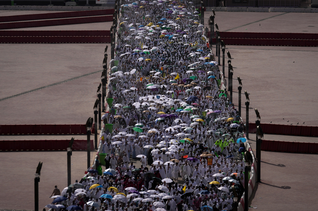 Muslim pilgrims walk on their way to cast pebbles at pillars in the symbolic stoning of the devil, the last rite of the annual Hajj, in Mina near the holy city of Mecca, Saudi Arabia, Wednesday, May 27, 2026. (AP Photo/Altaf Qadri)