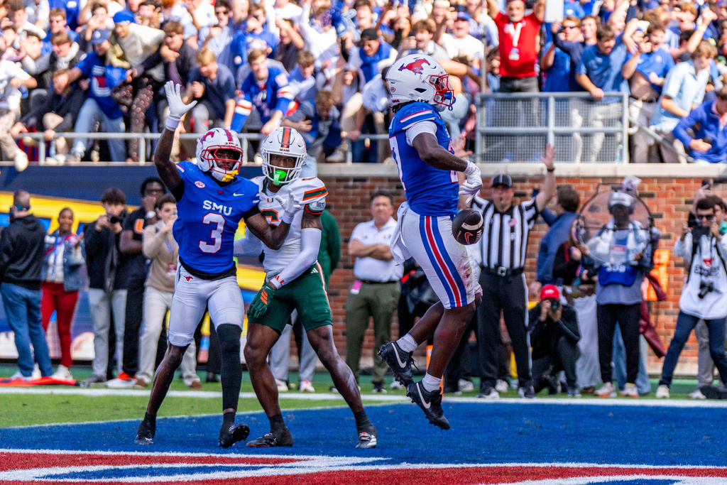 SMU running back T.J. Harden scores the game-winning touchdown as wide receiver Romello Brinson and Miami cornerback Xavier Lucas look on during overtime of an NCAA college football game, Saturday, Nov. 1, 2025, in Dallas. (AP Photo/Jeffrey McWhorter)