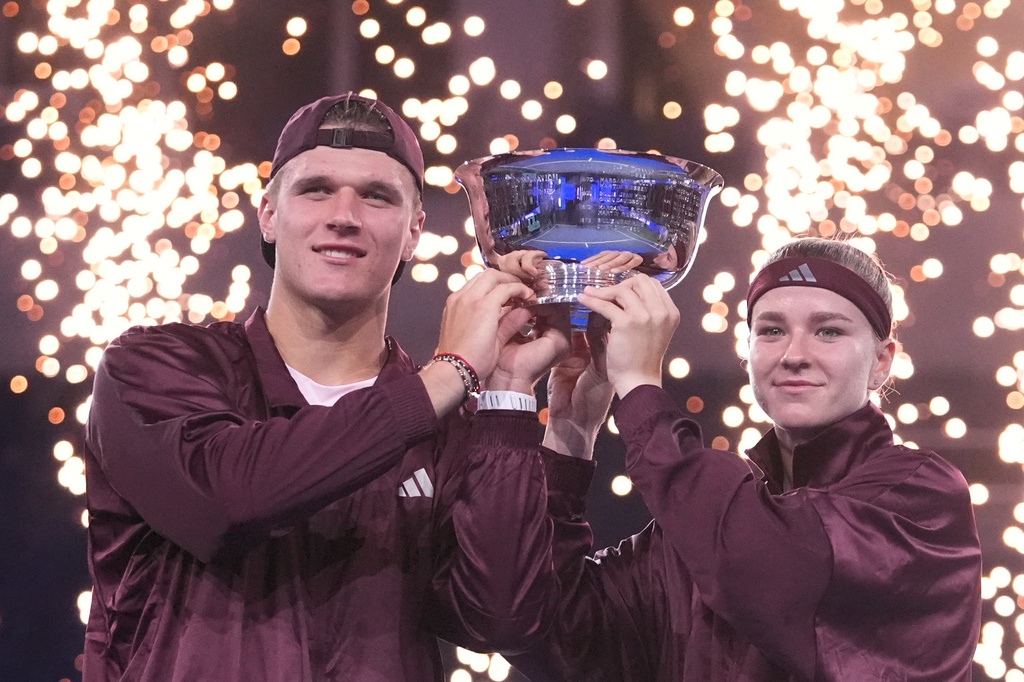 Jakub Mensik, left, and Karolina Muchova, both of the Czech Republic, pose with the trophy after defeating Belinda Bencic, of Switzerland, and Flavio Cobolli, of Italy, in the mixed doubles final match at the U.S. Open tennis championships Thursday, Aug. 27, 2026, in New York. (AP Photo/Frank Franklin II)
