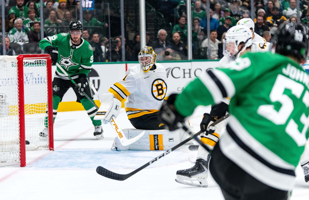 Dallas Stars center Wyatt Johnston (53) scores past Boston Bruins goaltender Jeremy Swayman (1) as center Matt Duchene looks on during the first period of an NHL hockey game, Tuesday, Jan. 20, 2026, in Dallas. (AP Photo/Jeffrey McWhorter)