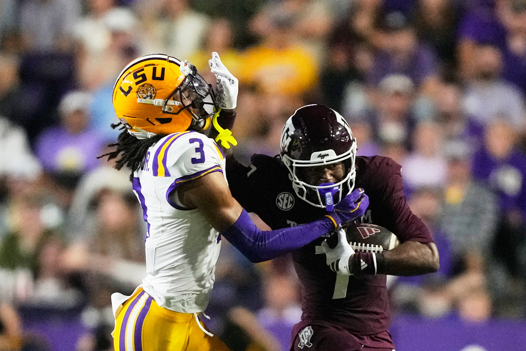 Texas A&M wide receiver KC Concepcion (7) carries against LSU cornerback DJ Pickett (3) in the first half of an NCAA college football game, Saturday, Oct. 25, 2025 in Baton Rouge, La. (AP Photo/Gerald Herbert)