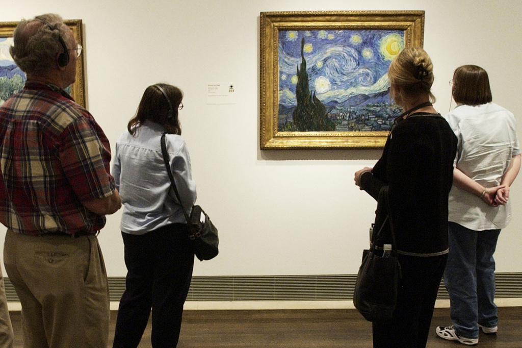 FILE - Visitors to the Museum of Fine Arts, Houston view Vincent van Gogh's painting, "The Starry Night," on Oct. 17, 2003, in Houston. (AP Photo/David J. Phillip, File)