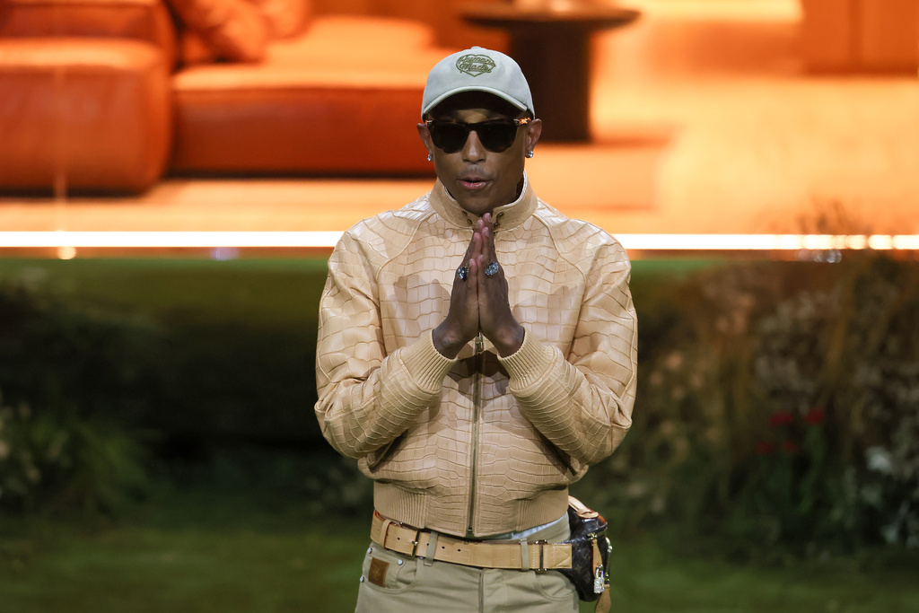 Designer Pharrell Williams accepts applause after the Louis Vuitton Fall/Winter 2026-2027 Men's collection presented in Paris, Tuesday, Jan. 20, 2026. (AP Photo/Thomas Padilla)