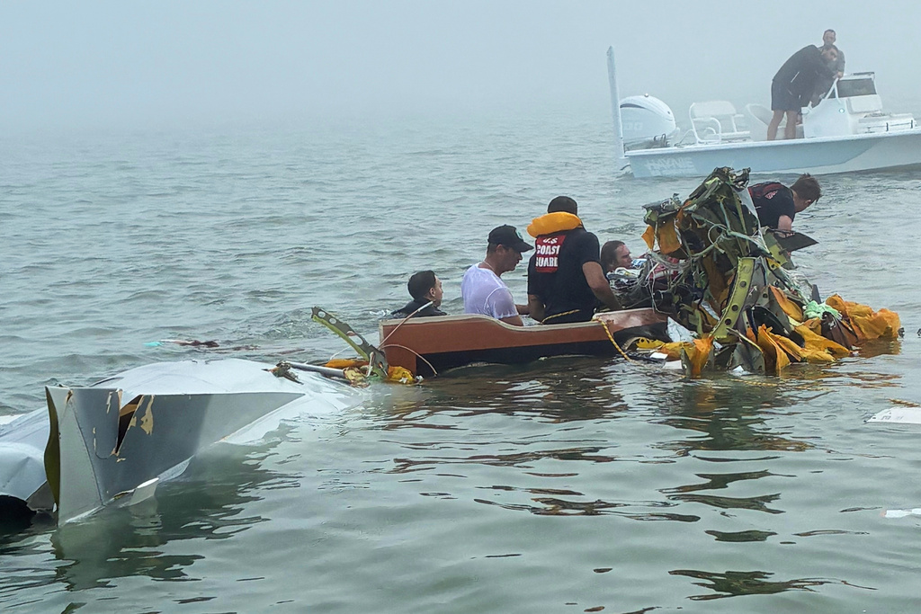 In this image provided by Sky Decker Jr., authorities and volunteers respond to a Mexican Navy plane crash near Galveston, Texas, Monday, Dec. 22, 2025. (Sky Decker Jr. via AP)null