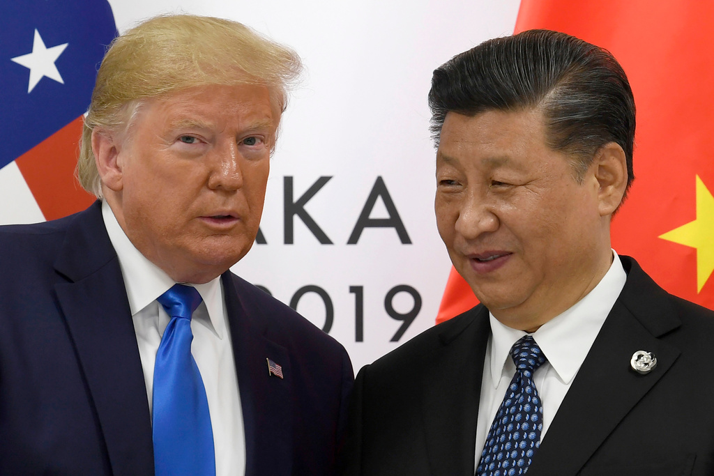 FILE - U.S. President Donald Trump poses for a photo with Chinese President Xi Jinping during a meeting on the sidelines of the G-20 summit in Osaka, western Japan, on June 29, 2019. (AP Photo/Susan Walsh, File)