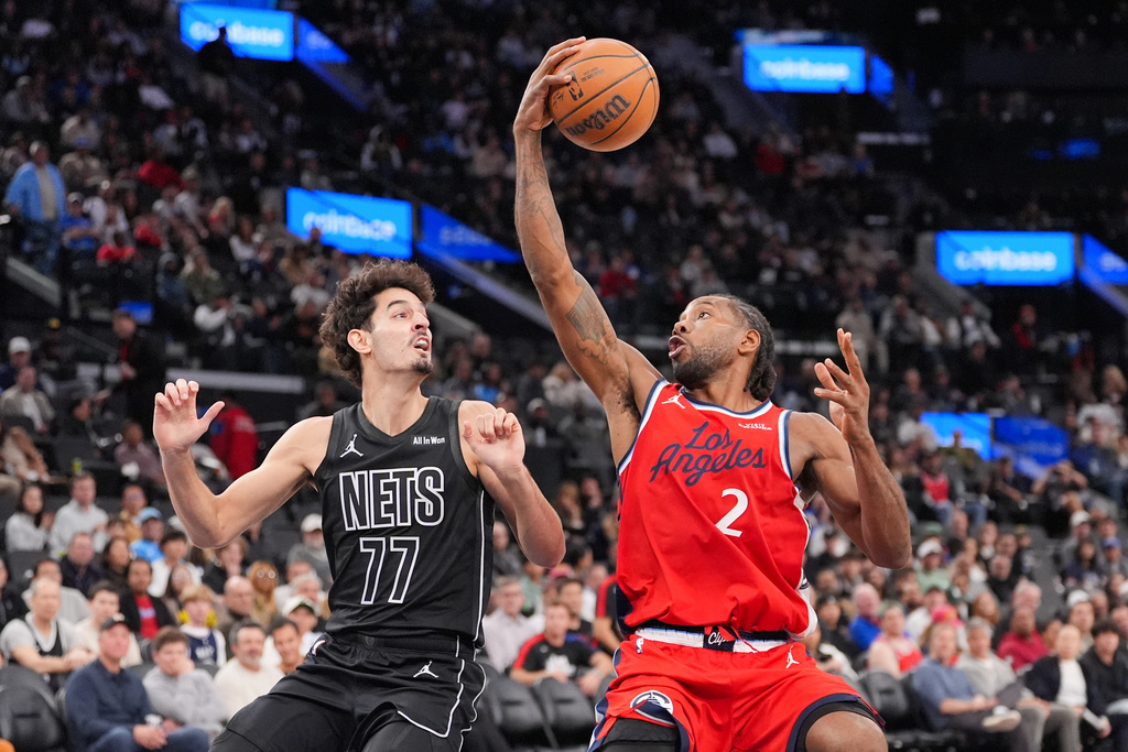 Los Angeles Clippers forward Kawhi Leonard (2) fakes a shot against Brooklyn Nets guard Ben Saraf during the second half of an NBA basketball game Sunday, Jan. 25, 2026, in Inglewood, Calif. (AP Photo/Jae C. Hong)