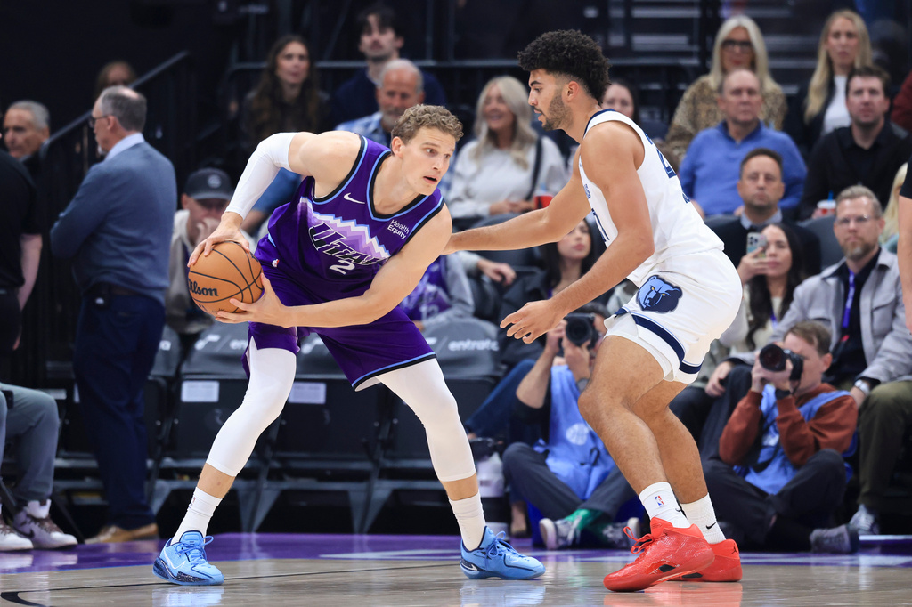 Utah Jazz forward Lauri Markkanen, left, looks for a play against Memphis Grizzlies forward Cameron Boozer, right, during the first half of an NBA basketball game, Monday, Oct. 26, 2026, in Salt Lake City. (AP Photo/Rob Gray)
