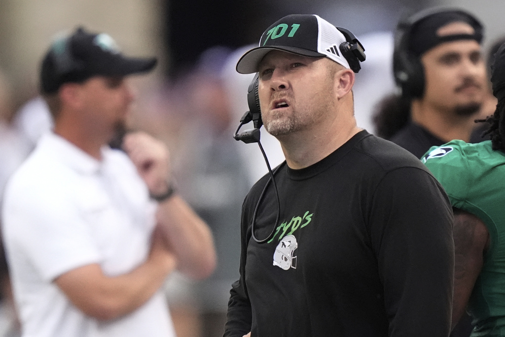 North Dakota head coach Eric Schmidt looks at the scoreboard during the first half of an NCAA college football game against Kansas State, Saturday, Aug. 30, 2025, in Manhattan, Kan. (AP Photo/Charlie Riedel)