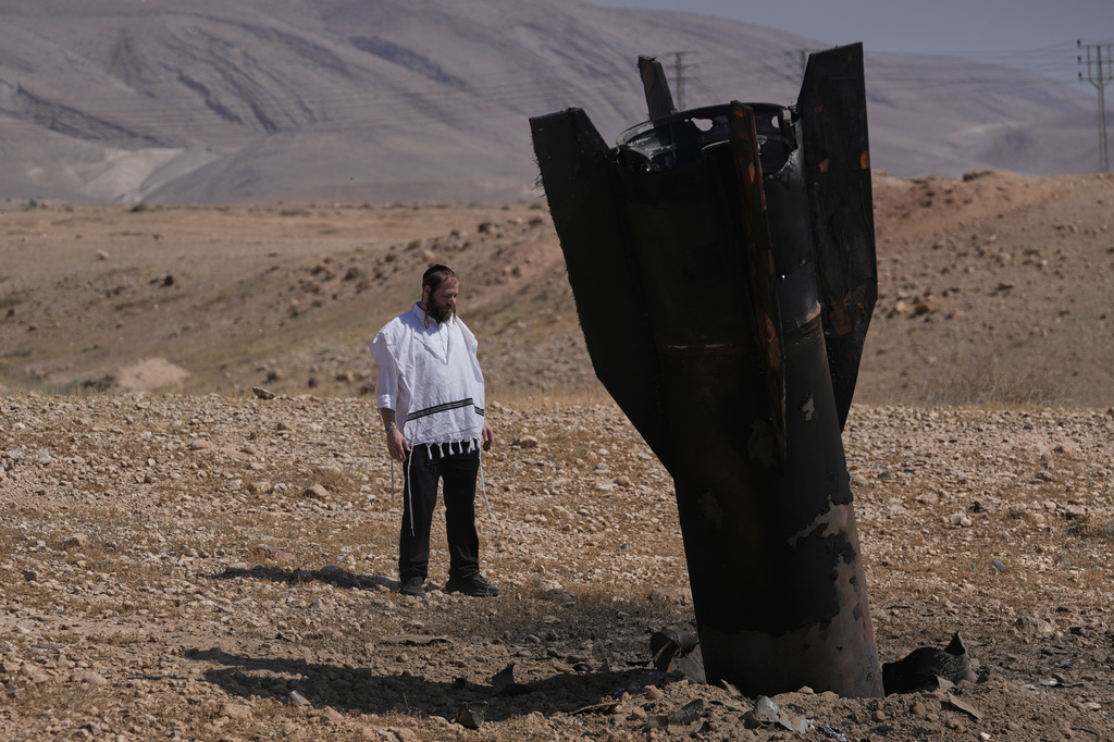 A man look at the wreckage of an Iranian missile that landed near the West Bank city of Jericho Monday, June 8, 2026. (AP Photo/Mahmoud Illean)