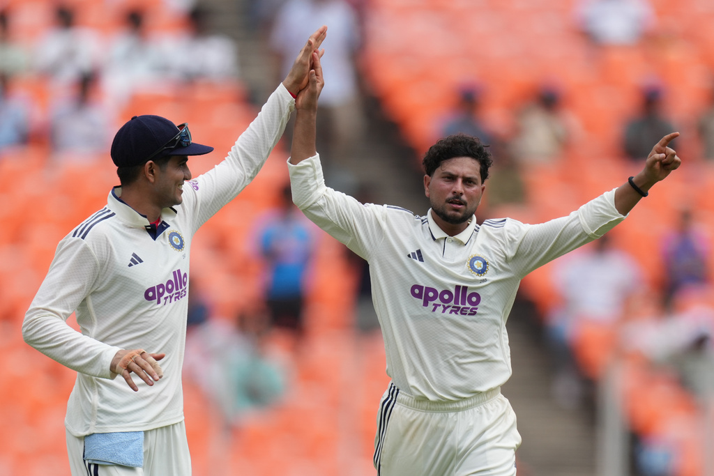 India's Kuldeep Yadav, right, and India's captain Shubman Gill celebrates the dismissal of West Indies' Shai Hope on the first day of the first Test cricket match between India and West Indies at Narendra Modi Stadium in Ahmedabad, India, Thursday, Oct. 2, 2025. (AP Photo/Ajit Solanki)