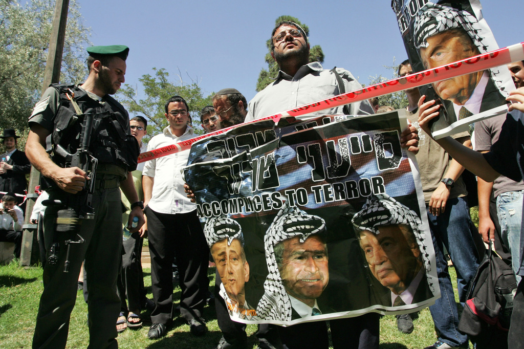 FILE - Itamar Ben-Gvir, center, demonstrates with other far-right activists at the site where a Palestinian driver rammed his construction vehicle into a bus and three cars in Jerusalem, July 22, 2008. (AP Photo/Sebastian Scheiner, File)