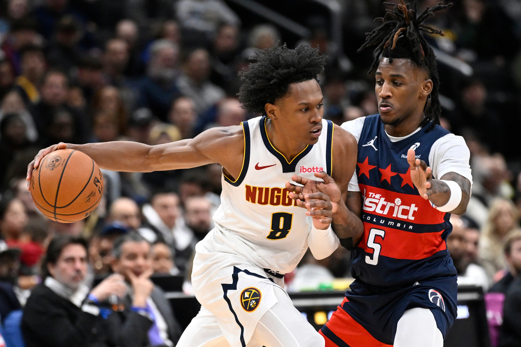 Denver Nuggets guard Peyton Watson (8) drive to the basket against Washington Wizards guard Jamir Watkins during the second half of an NBA basketball game, Thursday, Jan. 22, 2026, in Washington. (AP Photo/John McDonnell)