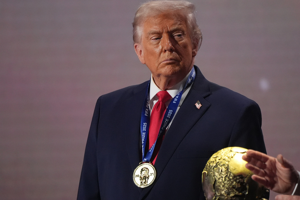 FILE - President Donald Trump stands on stage next to the FIFA World Cup after receiving the FIFA Peace Prize during the draw for the 2026 soccer World Cup at the Kennedy Center in Washington, Friday, Dec. 5, 2025. (AP Photo/Jacquelyn Martin, File)