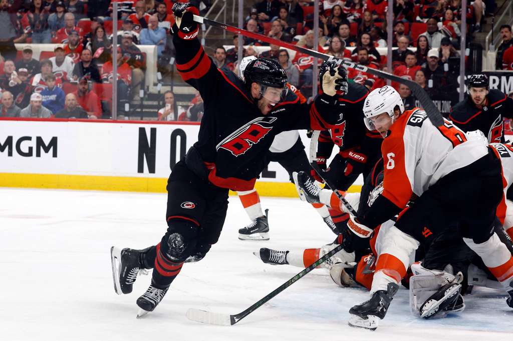 Carolina Hurricanes' Taylor Hall, left, celebrates after his winning overtime goal as Philadelphia Flyers' Travis Sanheim (6) looks on during Game 2 of an NHL hockey Stanley Cup second-round playoff series in Raleigh, N.C., Monday, May 4, 2026. (AP Photo/Karl DeBlaker)