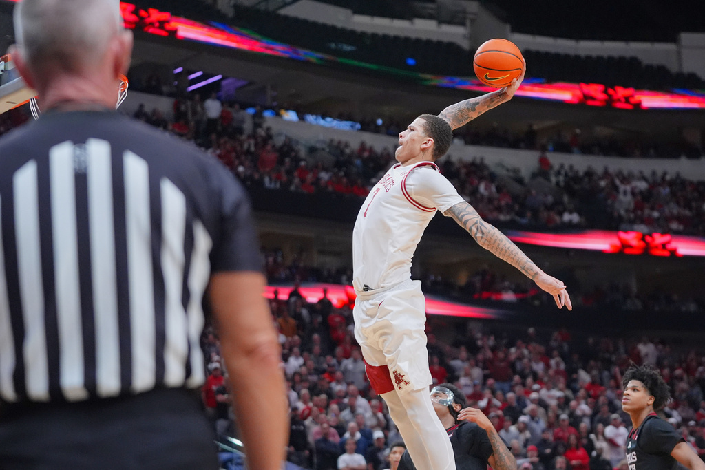Arkansas forward Trevon Brazile drives in for a dunk during the second half of an NCAA college basketball game against Texas Tech, Saturday, Dec. 13, 2025, in Dallas. (AP Photo/LM Otero)