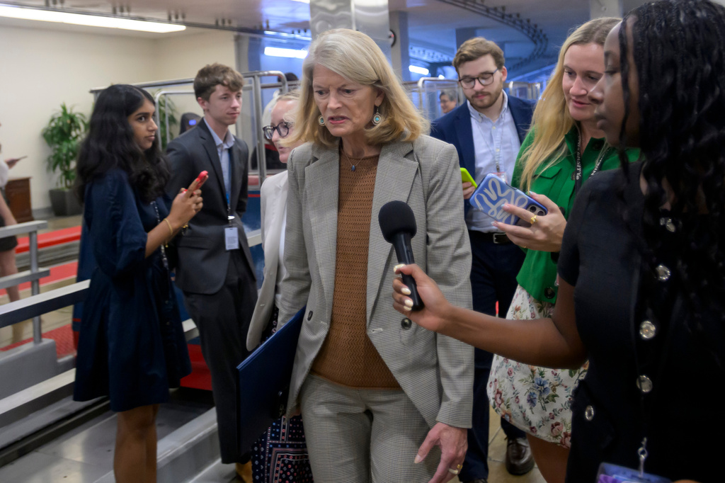 Sen. Lisa Murkowski, R-Alaska, talks with reporters as she walks through the Senate subway at the U.S. Capitol during a vote, Friday, August 7, 2026 in Washington. (AP Photo/Rod Lamkey, Jr.)