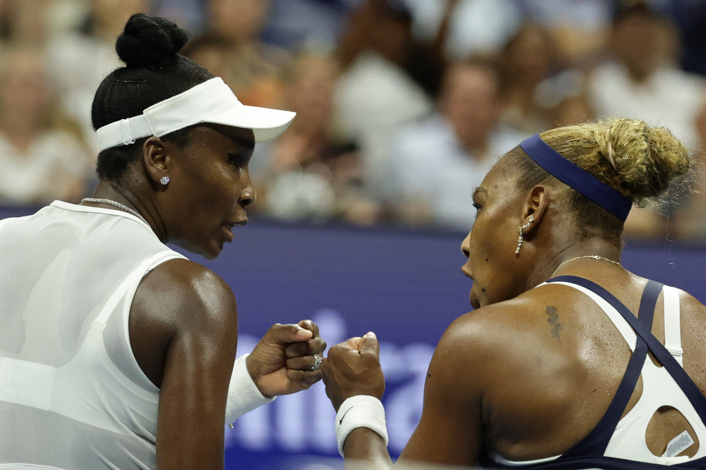 Venus Williams, right, and Serena Williams, of the United States, fist bump during the third set as they play against Hao-Ching Chan, of Taiwan, and Maya Joint, of Australia, during a women's doubles match at the U.S. Open tennis championships, Friday, Sept. 4, 2026, in New York. (AP Photo/Adam Hunger)