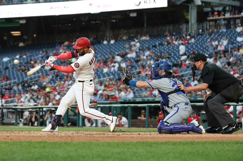 Washington Nationals' Luis García Jr., left, hits a single off Kansas City Royals pitcher Mitch Spence which scored Keibert Ruiz and Nasim Nuñez during the fifth inning of a baseball game, Monday, June 15, 2026, in Washington. (AP Photo/Terrance Williams)
