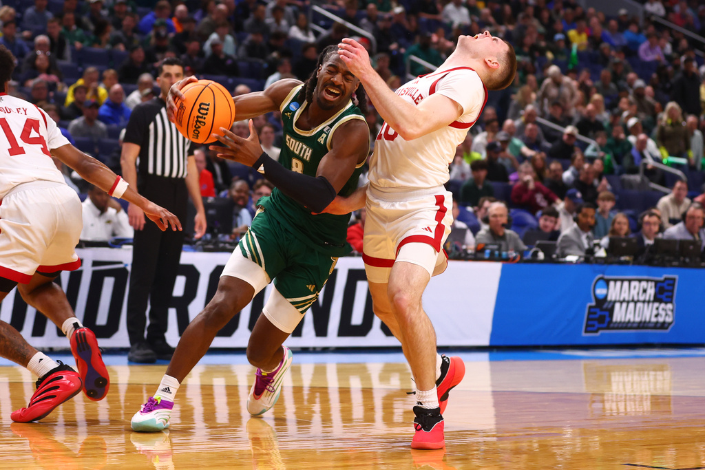 South Florida guard Josh Omojafo (8) collides with Louisville guard Isaac McKneely (10) during the first half in the first round of the NCAA college basketball tournament, Thursday, March 19, 2026, in Buffalo, N.Y. (AP Photo/Jeffrey T. Barnes)
