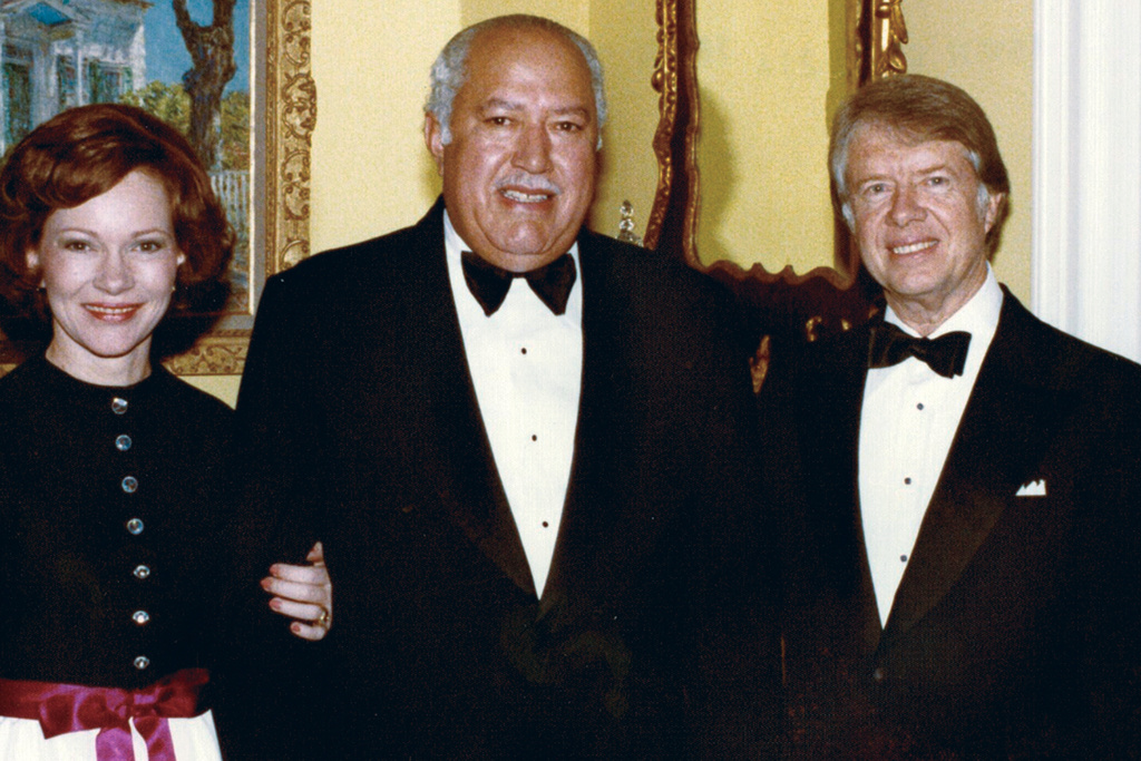 In this undated photo provided by The White House, John Woodson Ficklin poses for a photos with President Jimmy Carter and first lady Rosalynn Carter at the White House in Washington. (The White House via AP)