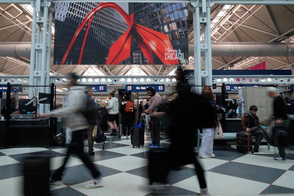 Travelers go through TSA security check at O'Hare International Airport, Saturday, March 21, 2026, in Chicago. (AP Photo/Kiichiro Sat0)