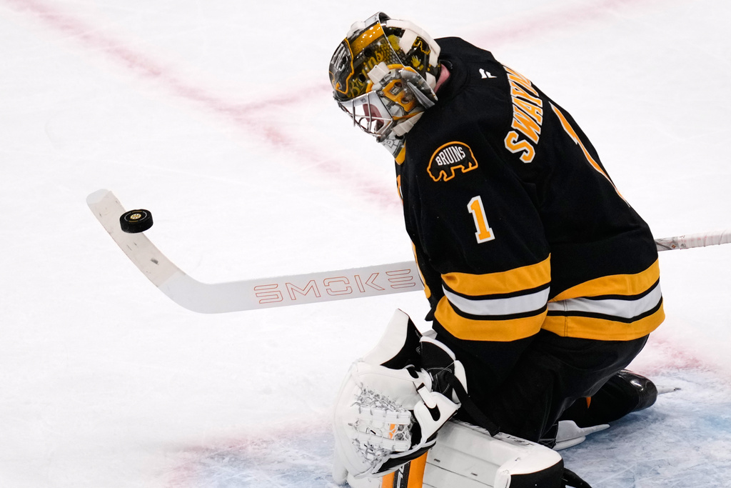 Boston Bruins goaltender Jeremy Swayman makes a stick save during the second period of an NHL hockey game against the Detroit Red Wings, Tuesday, Jan. 13, 2026, in Boston. (AP Photo/Charles Krupa)