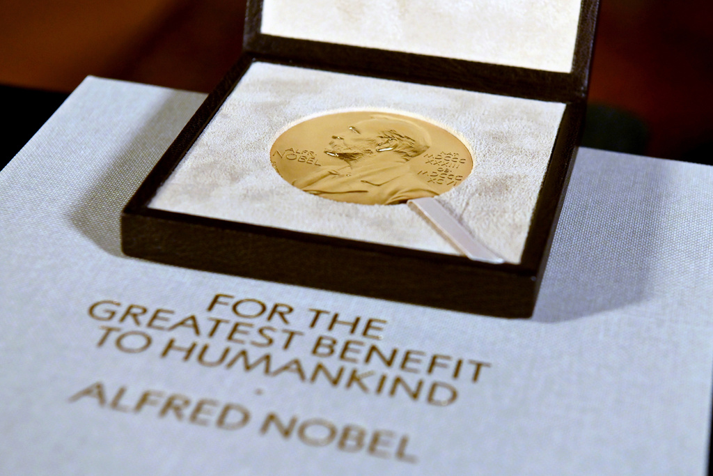 FILE - A Nobel diploma and medal are displayed, Dec. 8, 2020, during a ceremony in New York. (Angela Weiss/Pool Photo via AP, File)