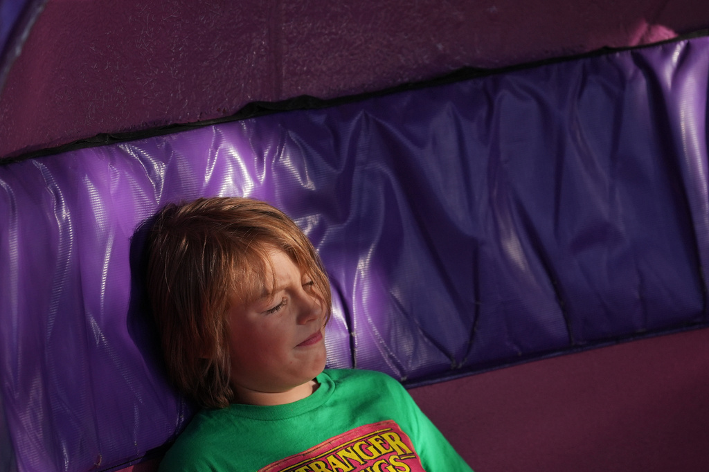 A child grimaces while riding the Tilt-A-Whirl, Thursday, Aug. 27, 2026, at the Minnesota State Fair in Falcon Heights, Minn. (AP Photo/Ellen Schmidt)