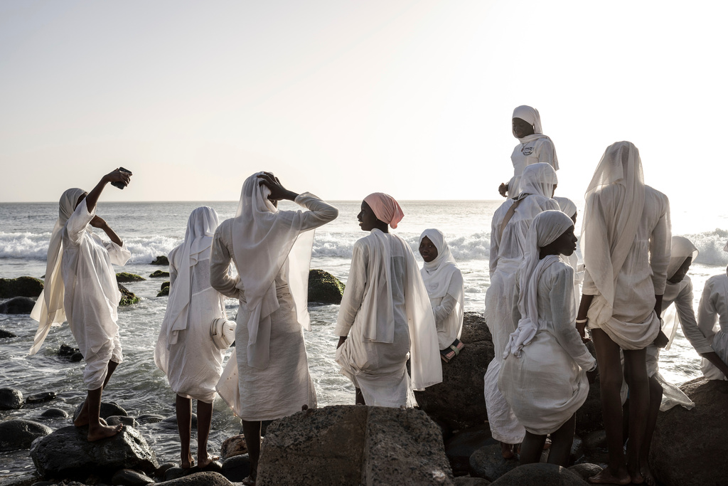 Followers from the Layene brotherhood gather near a sacred grotto where they believe their prophet received divine inspiration, in Ngor, Senegal, Jan. 30, 2025. (AP Photo/Annika Hammerschlag, File)