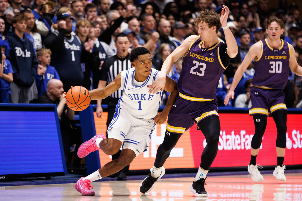 Duke's Caleb Foster (1) handles the ball as Lipscomb Kellan Boyland (23) defends during the first half of an NCAA college basketball game in Durham, N.C., Tuesday, Dec. 16, 2025. (AP Photo/Ben McKeown)
