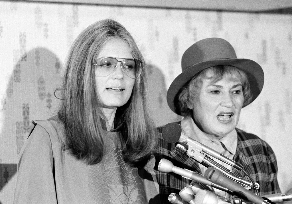 FILE - Gloria Steinem, secretary of Women USA, left, and former Congresswoman Bella Abzug, president of Women USA, answer questions at a press conference in Washington, Nov. 20, 1979. (AP Photo/Harvey Georges, File)