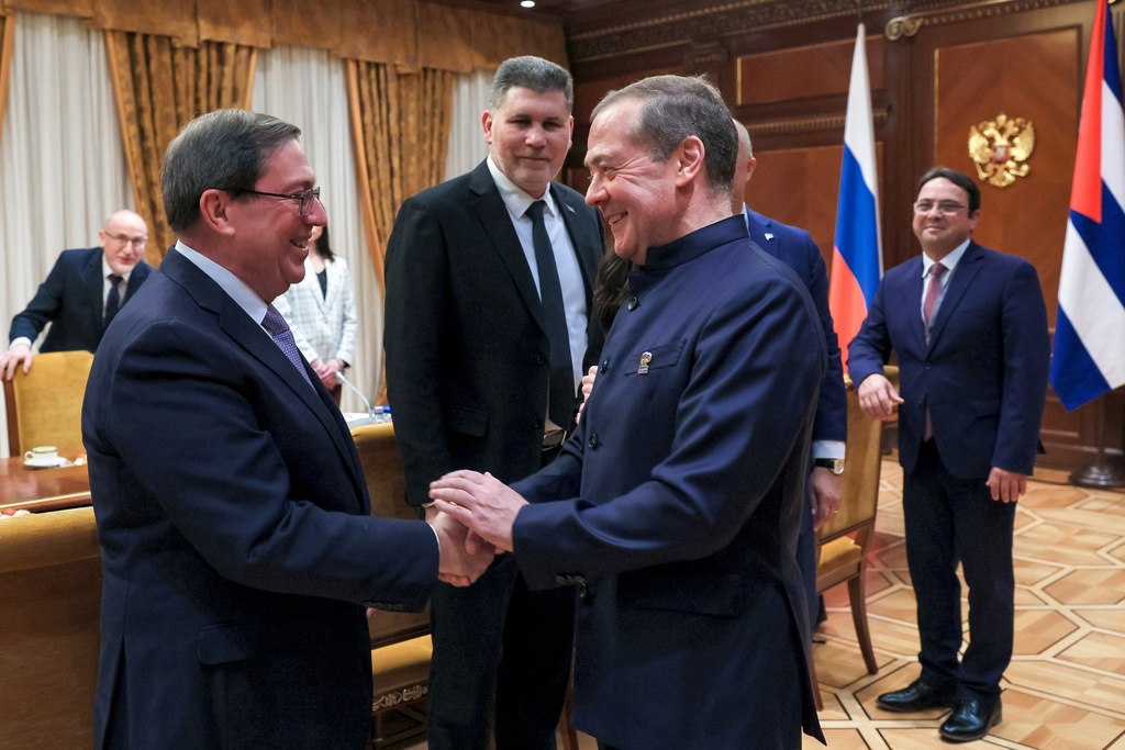 Cuban Foreign Minister Bruno Rodriguez, left, and Russian Security Council Deputy Chairman and the head of the United Russia party Dmitry Medvedev, foreground right, greet each other prior to their talks in Moscow, Wednesday, Feb. 18, 2026. (Ekaterina Shtukina, Sputnik Pool Photo via AP)