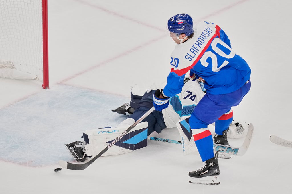 Slovakia's Juraj Slafkovsky (20) scores her side's opening goal during a preliminary round match of men's ice hockey between Slovakia and Finland at the 2026 Winter Olympics, in Milan, Italy, Wednesday, Feb. 11, 2026. (AP Photo/Petr David Josek)