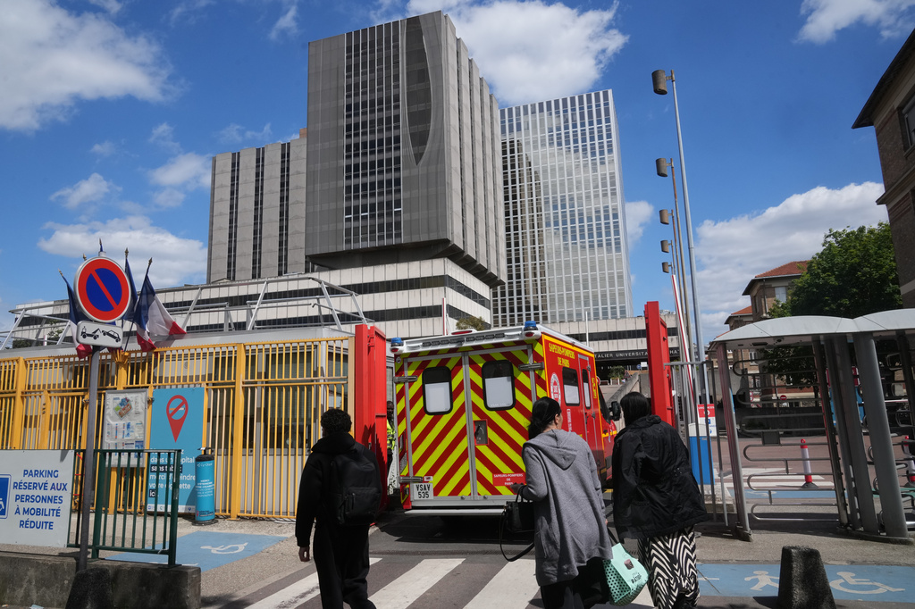 An ambulance enters the Bichat Hospital where a woman who tested positive for hantavirus remains in intensive care, in Paris, Tuesday, May 12, 2026. (AP Photo/Michel Euler)