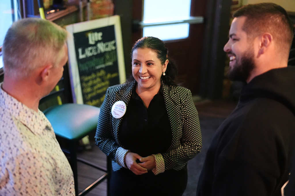 Carol Obando-Derstine, a candidate for the Democratic nomination in Pennsylvania's 7th Congressional District, speaks speaks with attendees at a social event in Bethlehem, Pa., Monday, May 11, 2026. (AP Photo/Matt Rourke)