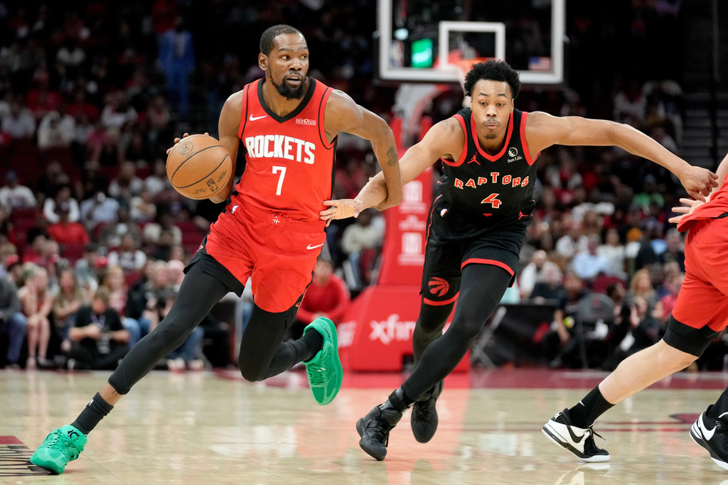 Houston Rockets forward Kevin Durant (7) dribbles as Toronto Raptors forward Scottie Barnes defends during the first half of an NBA basketball game Tuesday, March 10, 2026, in Houston. (AP Photo/Eric Christian Smith)