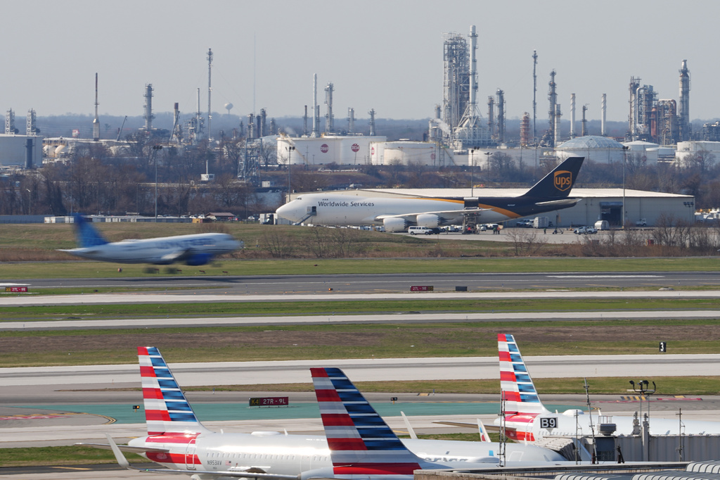 An airplane lands in view of a refinery at Philadelphia International Airport in Philadelphia, Thursday, March 26, 2026. (AP Photo/Matt Rourke)