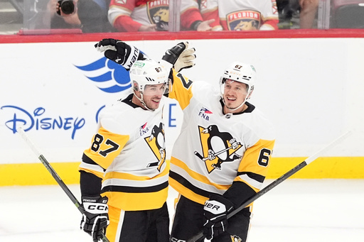 Pittsburgh Penguins center Sidney Crosby (87) celebrates with right wing Rickard Rakell (67) after scoring his team's first goal during the first period of an NHL hockey game against the Florida Panthers, Thursday, Oct. 23, 2025, in Sunrise, Fla. (AP Photo/Rebecca Blackwell) Pittsburgh Penguins center Sidney Crosby (87) celebrates with right wing Rickard Rakell (67) after scoring his team's first goal during the first period of an NHL hockey game against the Florida Panthers, Thursday, Oct. 23, 2025, in Sunrise, Fla. (AP Photo/Rebecca Blackwell)