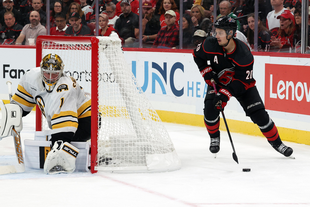 Carolina Hurricanes' Sebastian Aho (20) controls the puck behind Boston Bruins goaltender Jeremy Swayman (1) during the second period of an NHL hockey game in Raleigh, N.C., Tuesday, Oct. 27, 2026. (AP Photo/Karl DeBlaker)
