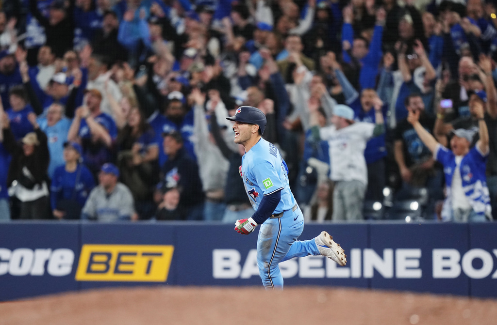 Toronto Blue Jays' Daulton Varsho (5) rounds the bases after hitting a walk-off grand slam against the Tampa Bay Rays during 10th inning MLB baseball action in Toronto on Wednesday, May 13, 2026. (Nathan Denette/The Canadian Press via AP)