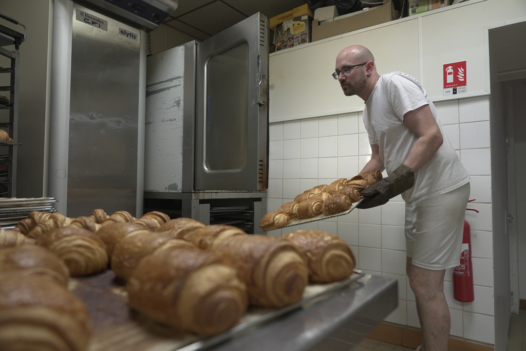 Baker Kevin Luce makes pastries in Saint-Just-en-Chaussee, France, Thursday Sept. 24, 2026. (AP Photo/John Leicester)