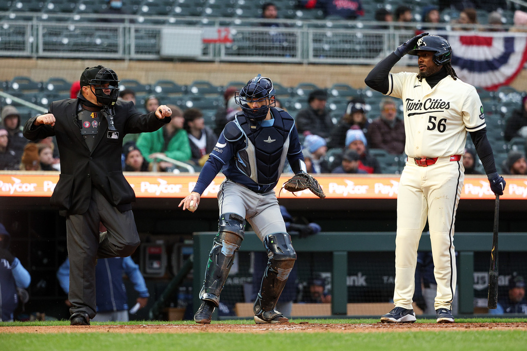 Minnesota Twins' Josh Bell, right, signals for an ABS challenge on a called third strike, which was upheld, during the first inning of baseball game against the Tampa Bay Rays, Saturday, April 4, 2026, in Minneapolis. (AP Photo/Matt Krohn)