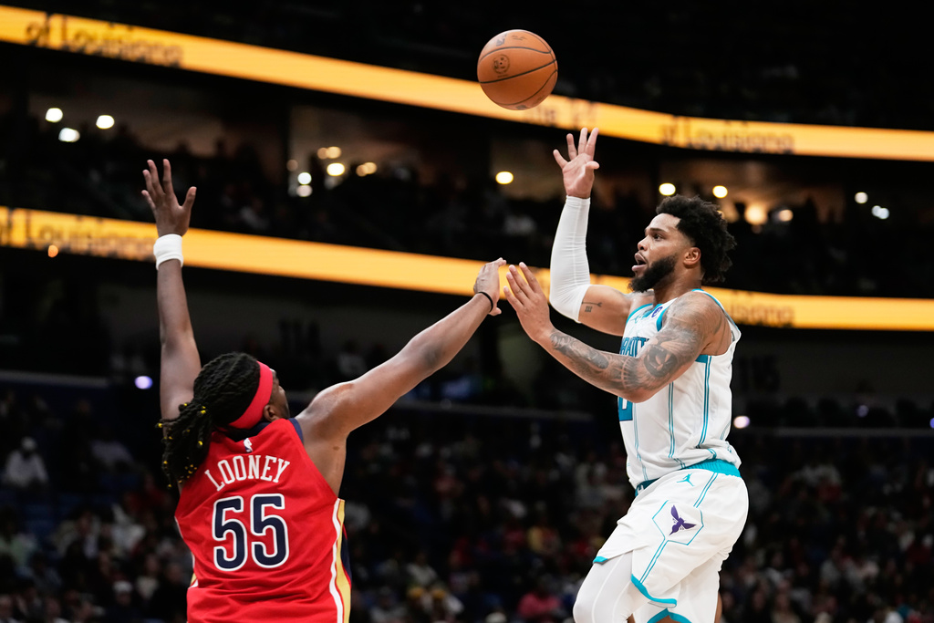 Charlotte Hornets forward Miles Bridges shoots against New Orleans Pelicans forward Kevon Looney (55) in the first half of an NBA basketball game, Tuesday, Nov. 4, 2025, in New Orleans. (AP Photo/Gerald Herbert)