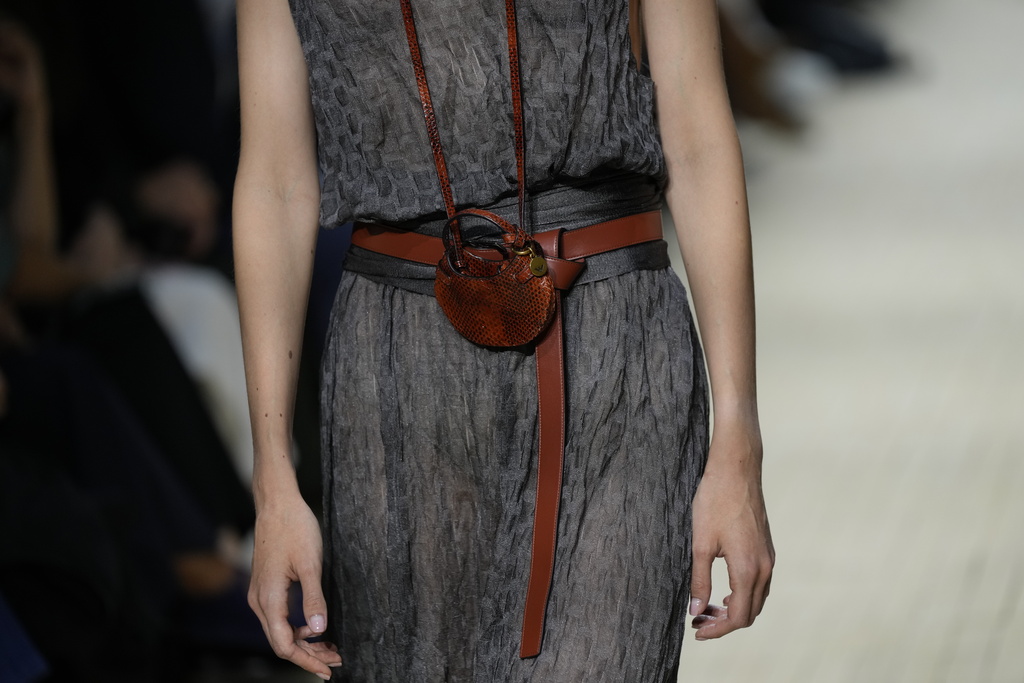 Models claps their hands as they wear creations part of the Emporio Armani women's Spring-Summer 2026 collection, presented in Milan, Italy, Thursday, Sept. 25, 2025. (AP Photo/Luca Bruno)