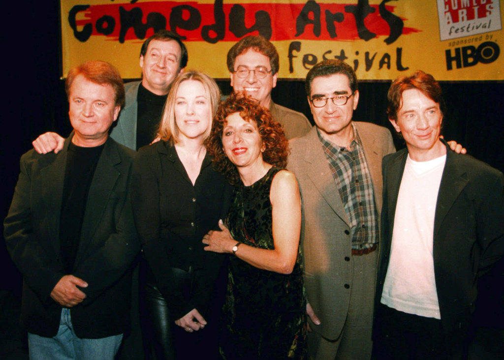 FILE - Former cast members of SCTV, from left, Dave Thomas, Joe Flaherty, Catherine O'Hara, Andrea Martin, foreground, Harold Ramis, Eugene Levy and Martin Short, pose at the U.S. Comedy Arts Festival on March 6, 1999, in Aspen, Colo. (AP Photo/E Pablo Kosmicki, File)