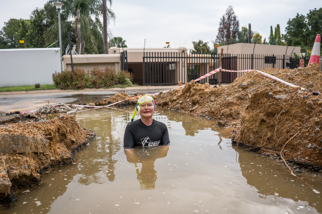 Johannesburg mayoral candidate Helen Zille takes a swim in a pool in a road created by a water leak in Johannesburg, South Africa, Saturday, March 28, 2026. (Jacques Nelles/Democratic Alliance via AP)