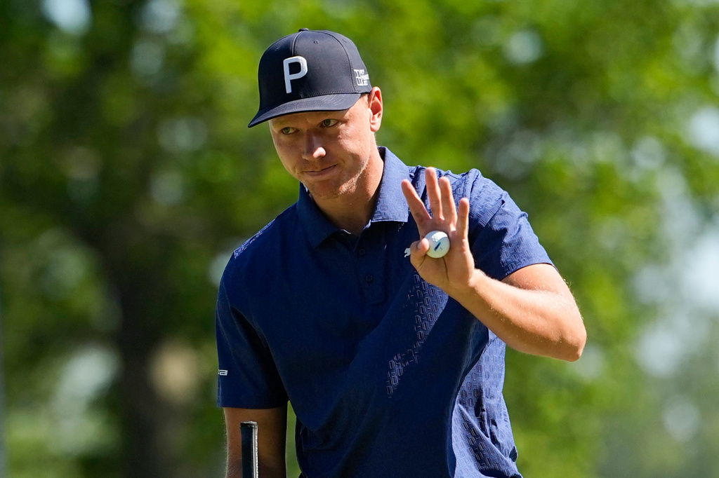 Matti Schmid, of Germany, waves on the 18th green during the third round of the PGA Championship golf tournament at Aronimink Golf Club, Saturday, May 16, 2026, in Newtown Square, PA. (AP Photo/Frank Franklin II)