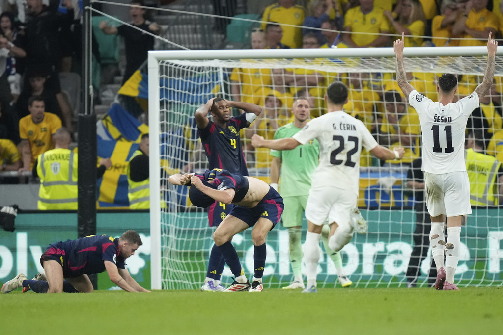 Slovienian players celebrate after scoring an equalizer during the World Cup qualifying soccer match between Slovenia and Sweden at the Stozice stadium in Ljubljana, Slovenia, Friday, Sept. 5, 2025. (AP Photo/Darko Bandic)