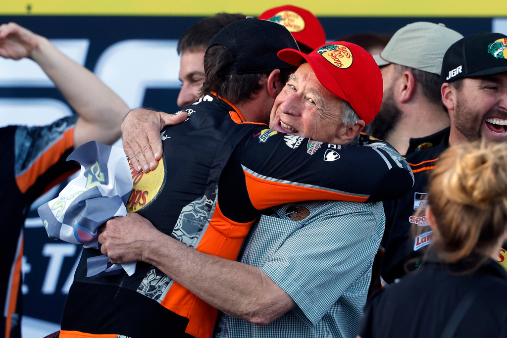 Driver Chase Briscoe, left, celebrates with Bass Pro Shop owner Johnny Morris after winning a NASCAR Cup Series auto race at Talladega Superspeedway, Sunday, Oct. 19, 2025, in Talladega, Ala. (AP Photo/Butch Dill)