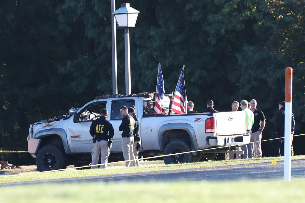 ATF police stand by the vehicle used to ram the exterior of the Church of Jesus Christ of Latter-day Saints, Monday, Sept. 29, 2025 in Grand Blanc Township, Mich. (AP Photo/Carlos Osorio)
